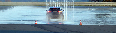 Auto bei einem Fahrsicherheitstraining auf nasser Fahrbahn